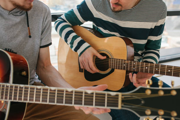 istock Learning to play the guitar. Music education and extracurricular lessons. 840275514
