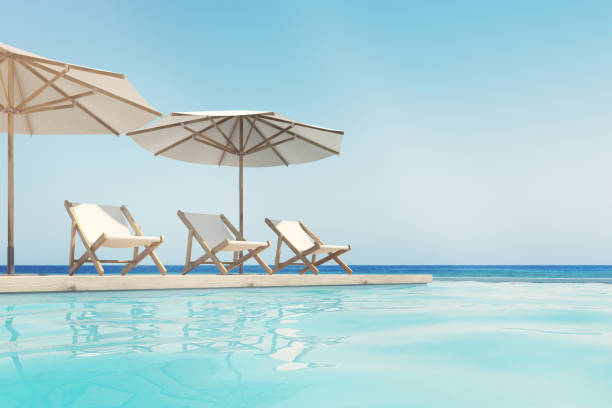istock Swimming pool, deck chairs, umbrellas, horizon 840275744