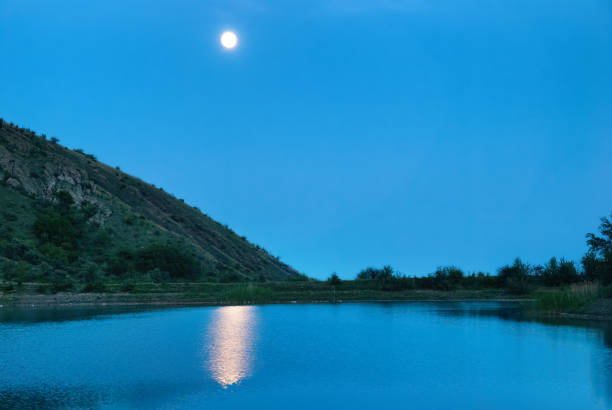 istock Landscape with moon above the lake 840280484