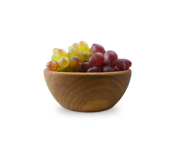 istock Grapes in a wooden bowl isolated on white background. 840282656
