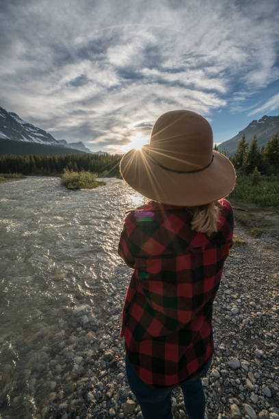 istock Female admiring nature by the river at sunset 840283156