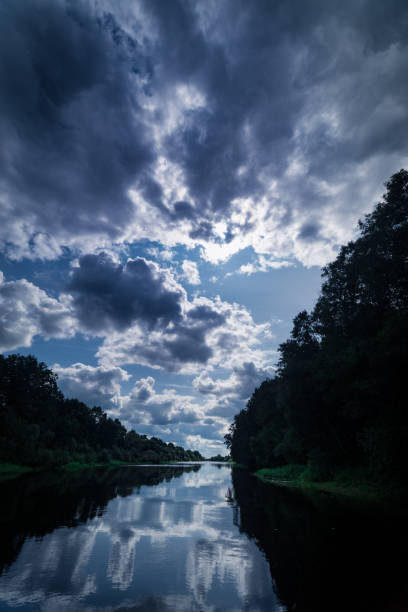istock Large river and green shores. Clouds and blue sky above. Still water 840283220