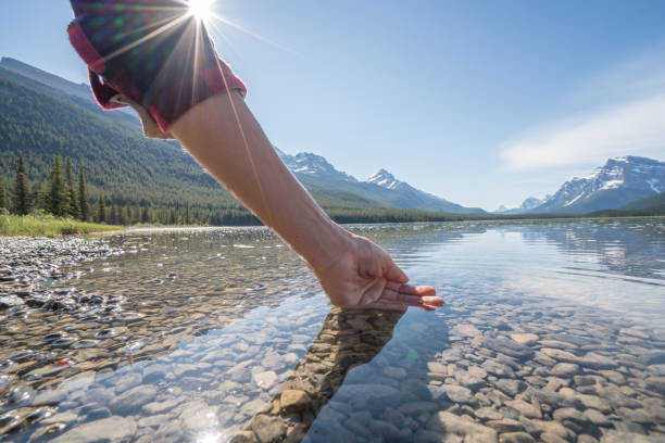 istock Human hand cupped to catch fresh water from mountain lake 840285936