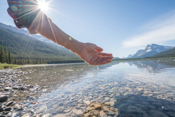 istock Human hand cupped to catch fresh water from mountain lake 840285950