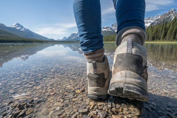 istock Hikers reaching mountain lake, boots close up 840286096