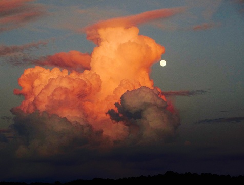 Moon about to be devoured by an orange cloud