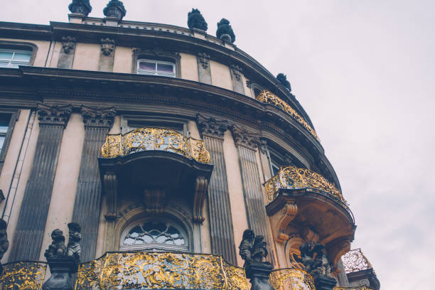 luxury curved building with golden balconies