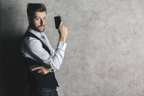 istock Businessman with cellphone gun 840294004