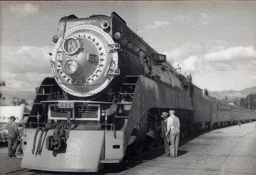 South Virginia, USA, 1952. A train is serviced by a technician at a section of the track in South Virgina.