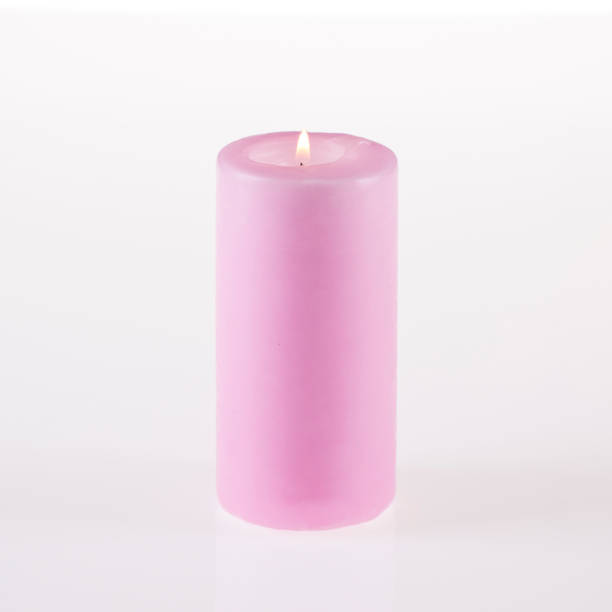 istock A candle of pink color burning. White background 840306232