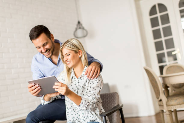 istock Young couple with tablet in the room 840309594