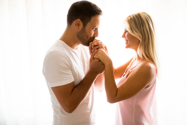 istock Lovely young couple standing by the window 840309710
