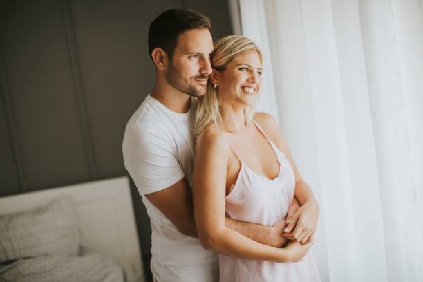 istock Lovely young couple standing by the window 840309726