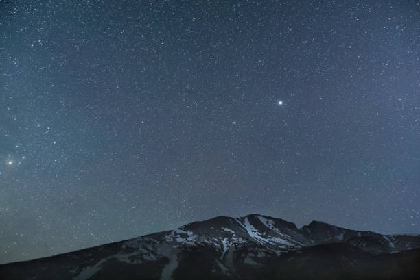 istock Intensely starry sky over snowy mountain 840310660
