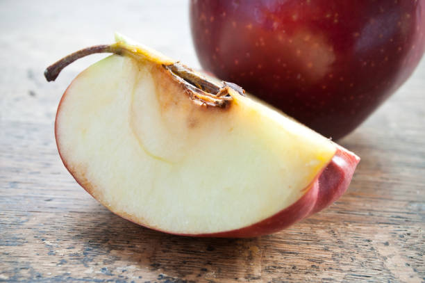 istock red  sliced apple on wooden table 840329640