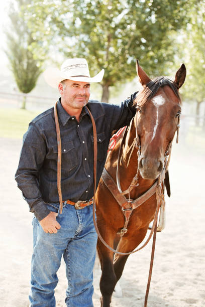 istock Cowboy Standing With His Horse At A Rodeo 840330184