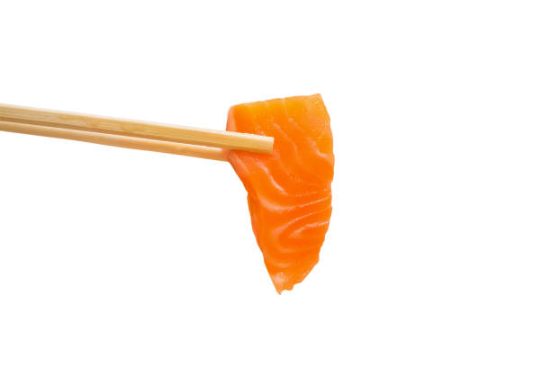 istock Salmon slice sashimi in chopsticks isolated on white background 840333350