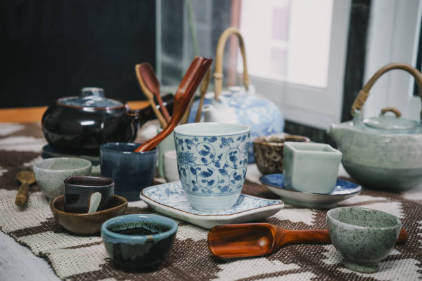 istock Tea cups with teapot on old wooden table 840336670