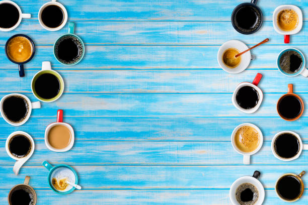istock Many cups of coffee on blue background. Top view 840336678