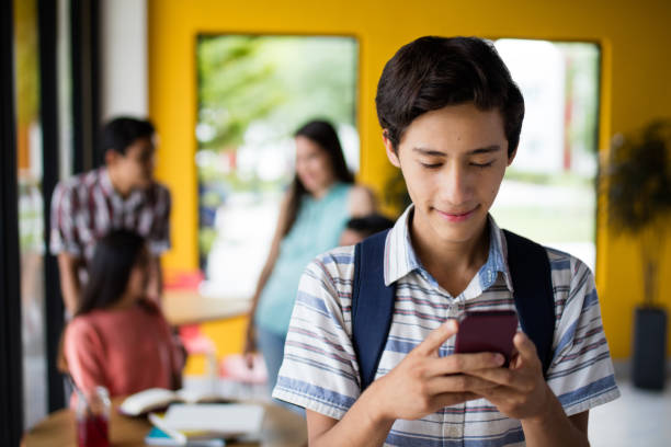 istock Male college student texting with mobile phone 840341082