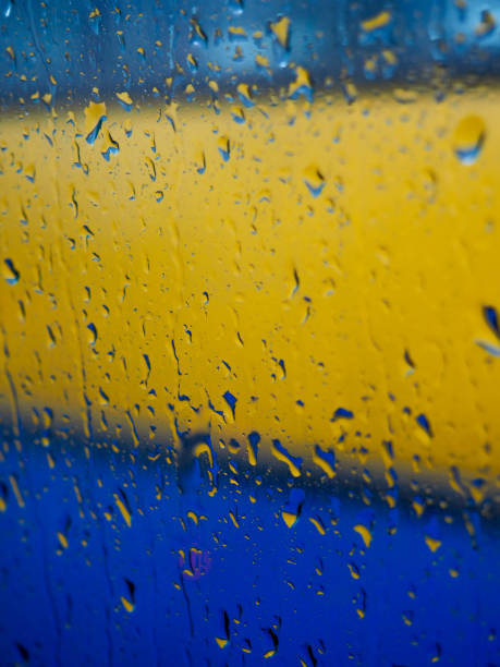 istock Water drops at gradient background, covered with water drops - condensation, close - up, color yellow and blue 840341284