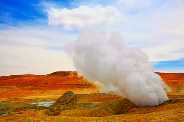 Dramatic Landscape: Geysers de La manana (Morning geysers) sulphur craters fumes at sunrise and Idyllic Atacama Desert puna exoticism, snowcapped Volcanic landscape panorama – Potosi Region, Bolivian Andes, Chile, Bolívia and Argentina border