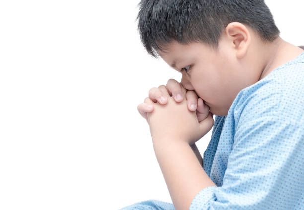 fat boy praying isolated over white background. asian boy hand praying, Hands folded in prayer concept for faith, spirituality and religion.