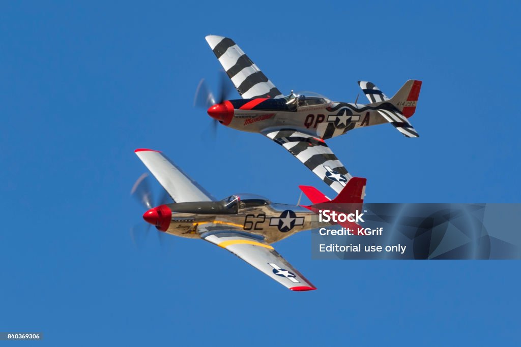 Airplanes pair of P-51 Mustang WWII fighters Los Angeles, California ,USA - August 19,2017. Pair of P-51 Mustang WWII aircraft flying at 2017 Camarillo Air Show. The 2017 Camarillo Airshow features vintage WWII aircraft flying for the public outside Los Angeles. Tuskegee Airmen Stock Photo
