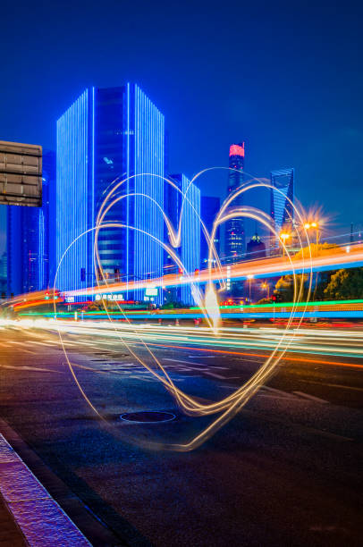 istock Traffic light trails with heart shape light draw in downtown 840369660
