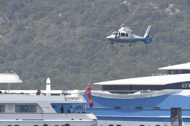 A helicopter is landing on a luxurious yacht in Sardinia, Italy Sardinia, Italy, July 21 - 2017, A helicopter is landing on a luxurious yacht in Sardinia, Italy helicopter landing on yacht stock pictures, royalty-free photos & images
