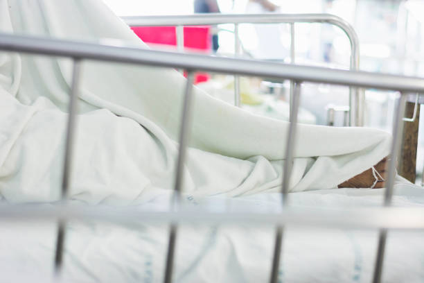 istock leg of patient on bed with cover 840373260