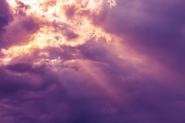 sky and clouds Overcast dark purple sky with orange yellow sun beam light from heaven Aflame stock pictures, royalty-free photos & images