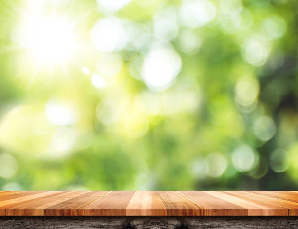 istock Empty brown wood table top with green blur nature sun light,Mock up for display or montage of product 840385364