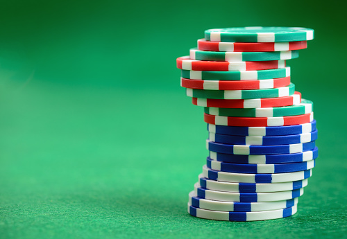 Casino poker chips  on green table background with copy space for your text