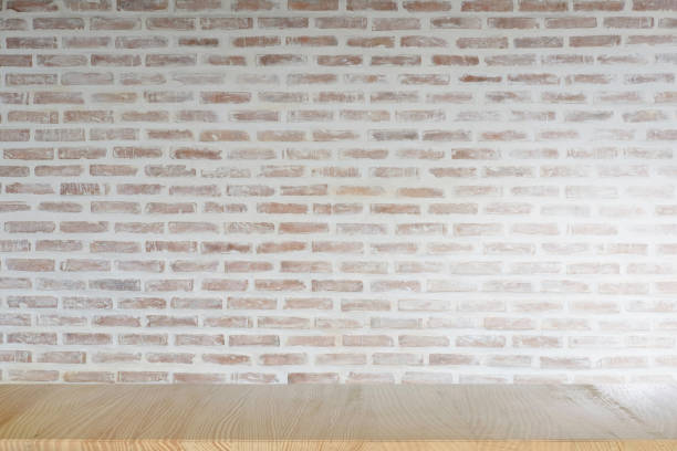 istock Mock up wooden table with white brick wall. For product display montage. 840392268