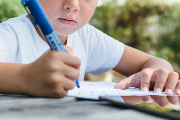 istock Crop child studying in garden 840404076