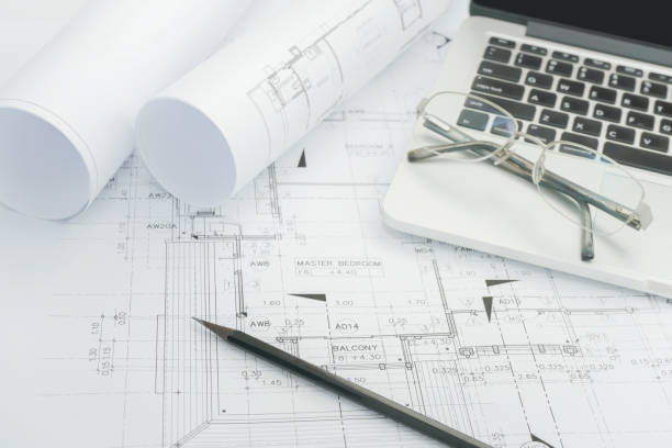 istock black pencil and computer laptop on architectural drawing paper for construction 840404236