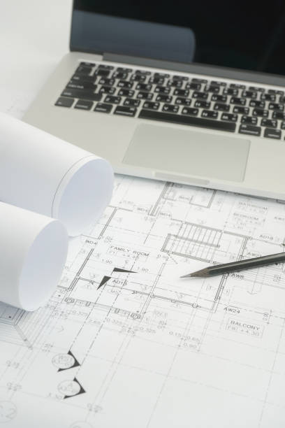 istock black pencil and computer laptop on architectural drawing paper for construction 840404388