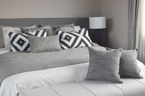 istock Graphic style and grey shade pillows on classic color bedding set up 840404436
