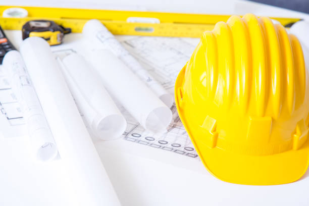 istock Yellow safety helmet and plan drawing 840407918