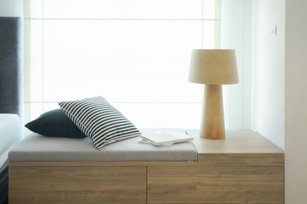 istock Pillows and reading lamp on cozy seat by the window next to bed 840408690