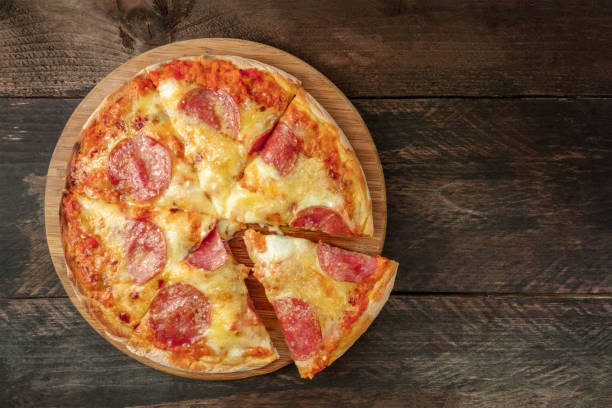 istock Pepperoni pizza with slice cut off and place for text 840412026