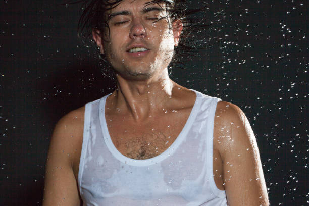 istock boy shakes his head under the rain 840412682