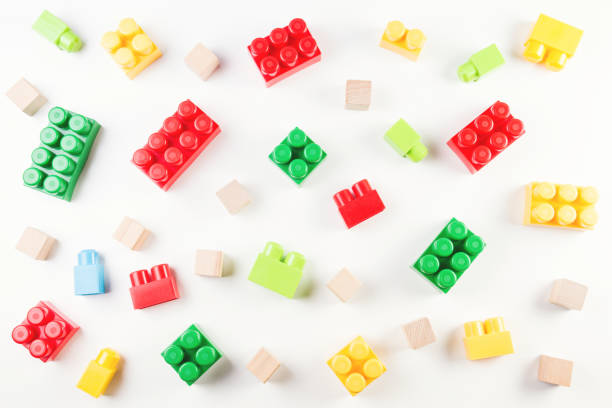 istock Colorful wooden cubes and plastic construction blocks on white background 840412752