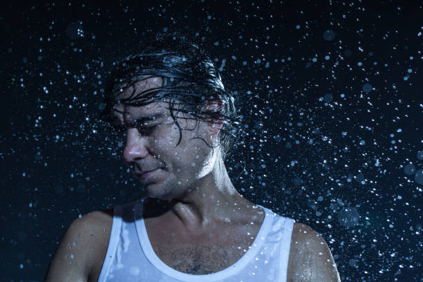 istock boy shakes his head under the rain 840412808