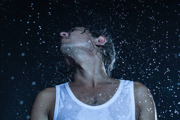 istock boy shakes his head under the rain 840412826