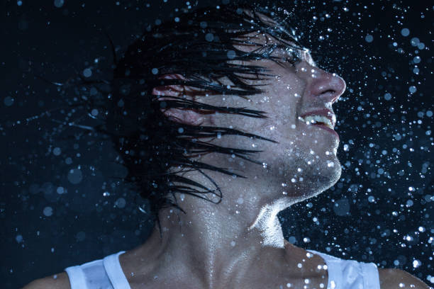 istock boy shakes his head under the rain 840412892