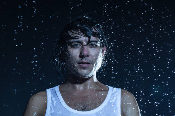 istock boy shakes his head under the rain 840412894