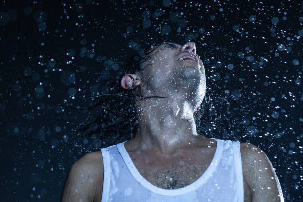 istock boy shakes his head under the rain 840412948