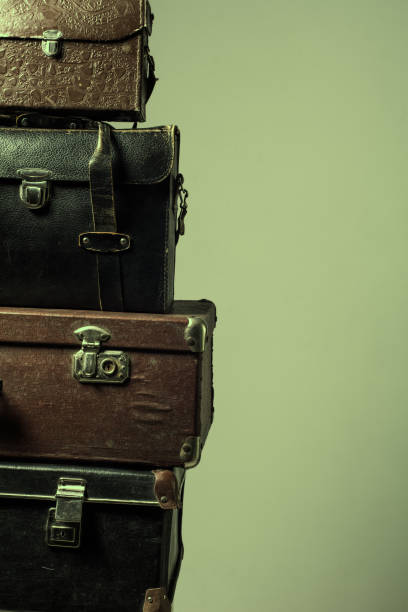istock Background stack of old shabby suitcases form a tower 840416032